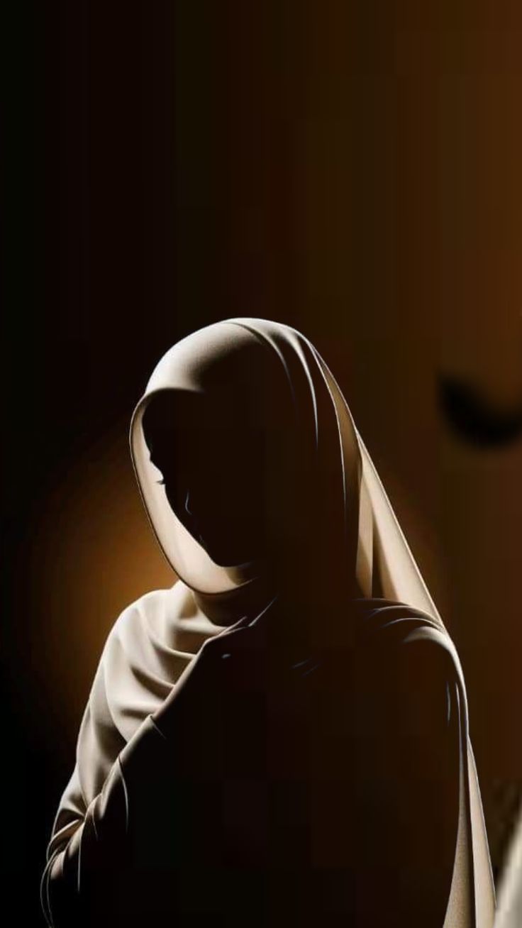 A student haloed in warm light, hijab catching the glow.